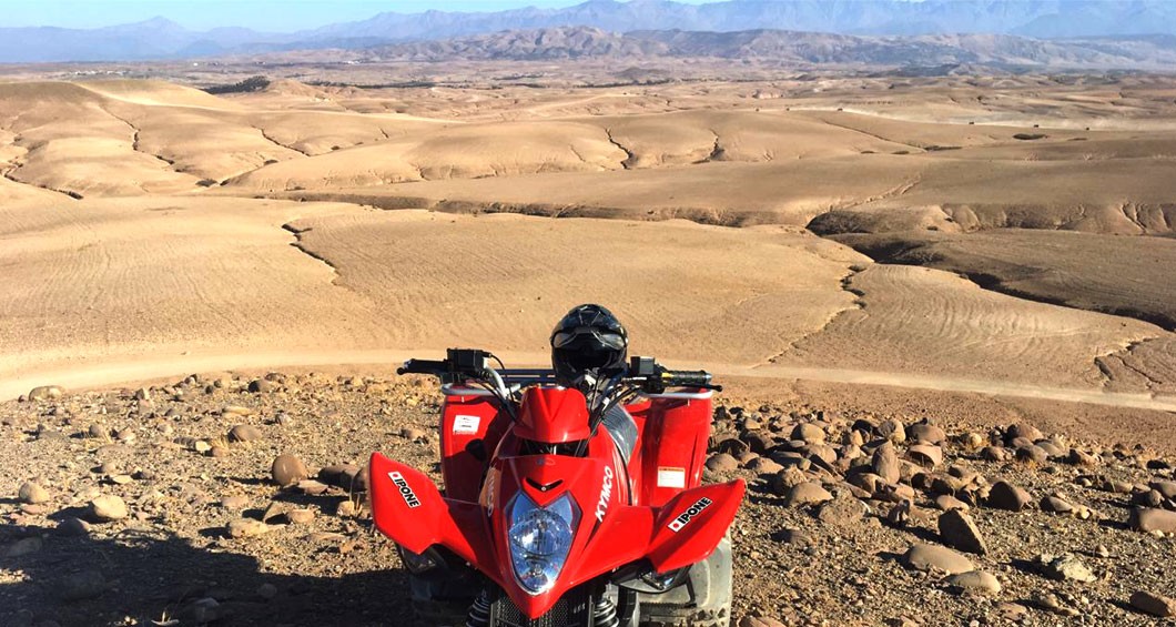 Quad biking across the rocky Agafay desert near Marrakech at golden hour
